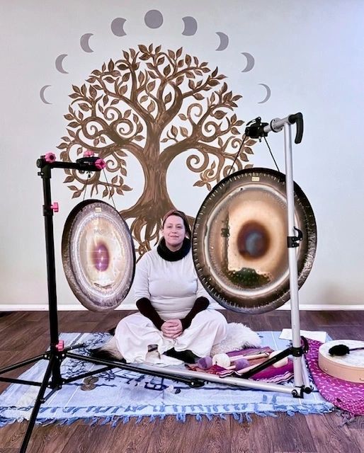 Woman sitting with musical gongs